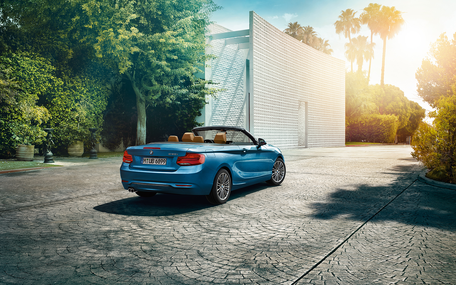 Geparktes blaues BMW 230i Cabrio vor einem modernen Haus, Heckansicht Geparktes blaues BMW 230i Cabrio vor einem modernen Haus, Heckansicht