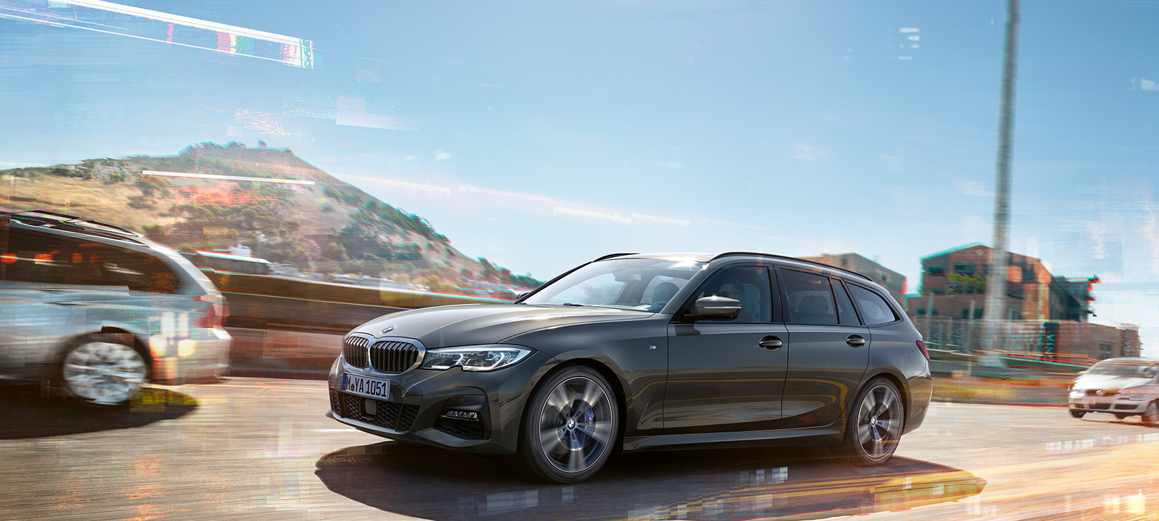 BMW 3er Touring, seitliche Fahraufnahme BMW 3er Touring, seitliche Fahraufnahme vor Häusern