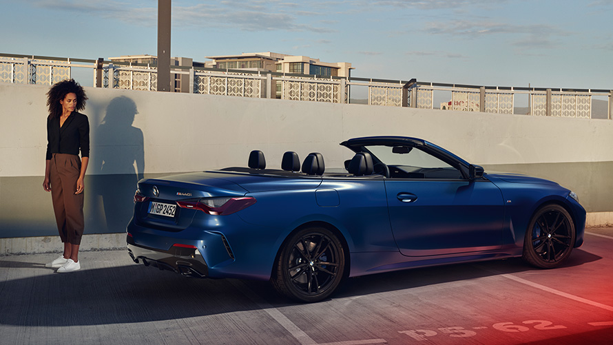 BMW Financial Services für das BMW 4er Cabrio Paar steht vor weißem BMW X in Halle BMW Financial Services