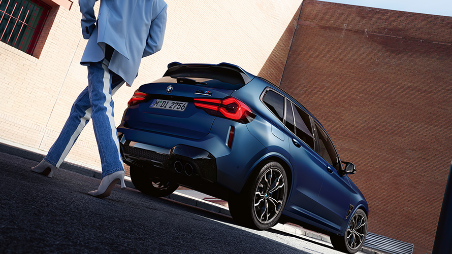 BMW X3 M Competition F97 LCI Facelift 2021 Frozen Marina Bay Blau metallic Dreiviertel-Heckansicht mit Model Froschperspektive