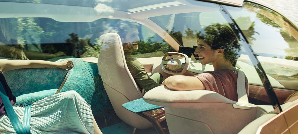 Interieur des BMW Vision iNEXT Interieur des BMW Vision iNEXT mit Frau, die sich in den Fond umdreht