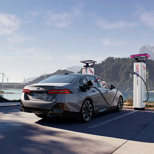 BMW i5 eDrive40 G60 an Ladesäule vor einem See