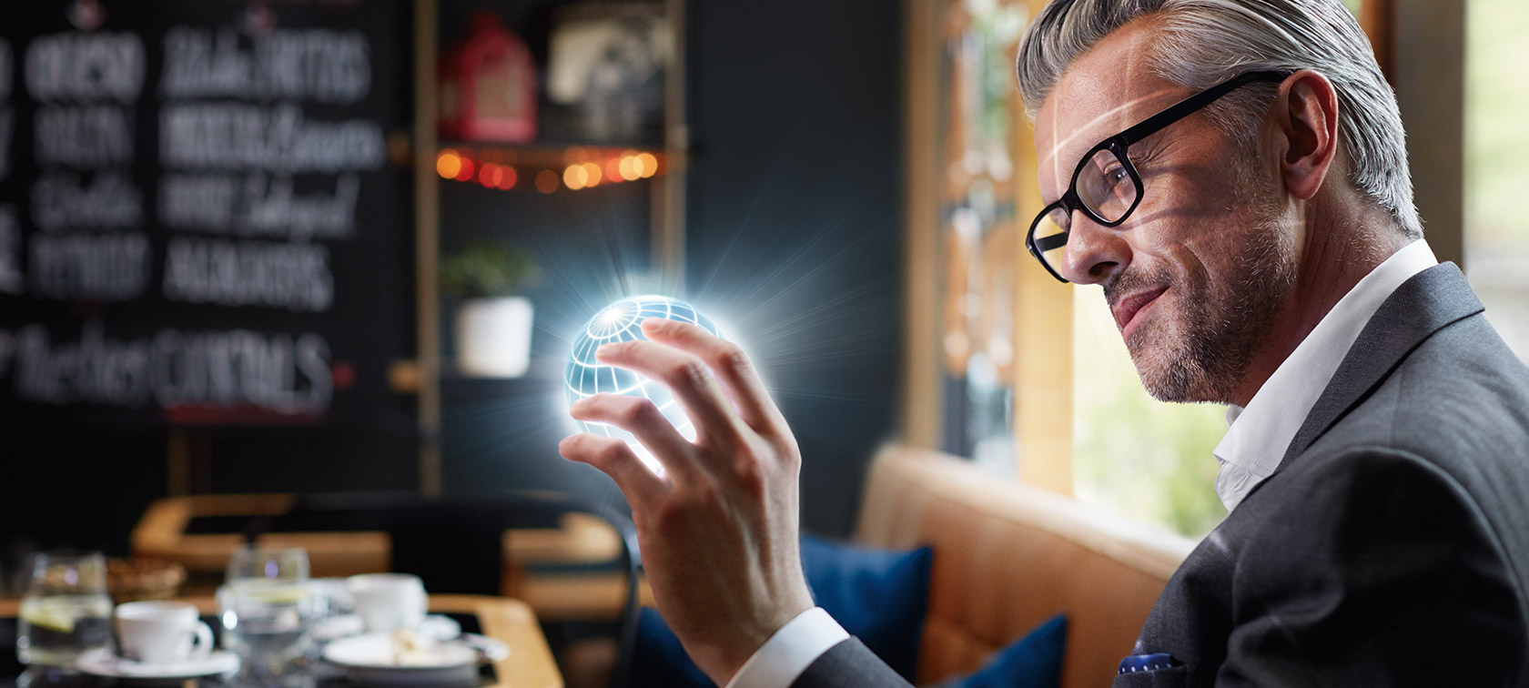 BMW ConnectedDrive Digital Services Mann hält den ConnectedDrive Globus in der Hand und ist fasziniert.