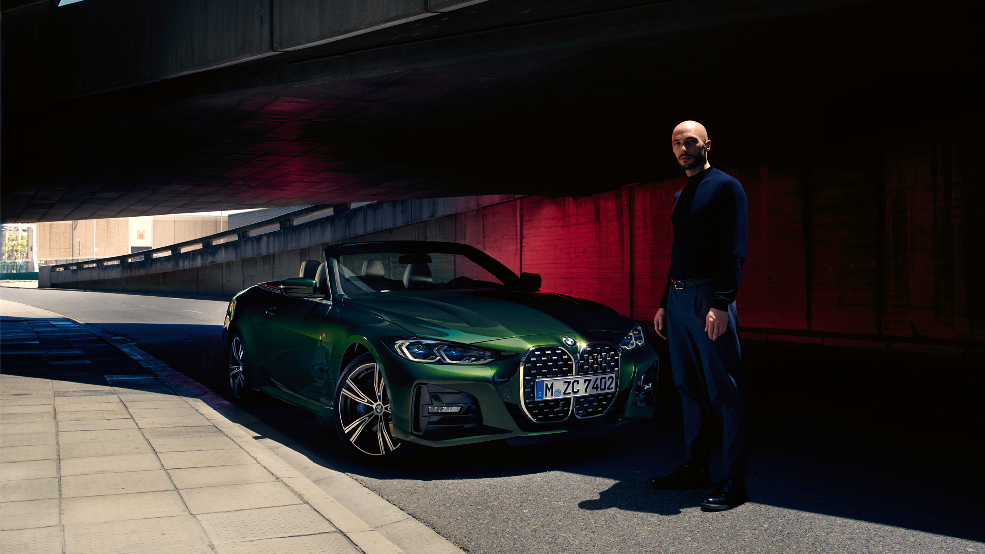 Dreiviertel-Frontansicht BMW 4er Cabrio G23 2020 mit Mann BMW 4er Cabrio G23 2020 Sanremo Green metallic Dreiviertel-Frontansicht mit Mann daneben